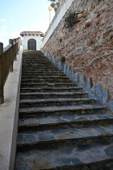 Fototapeta premium Stone Stairway Leading to Spanish Style Gate on Coastal Cliff 