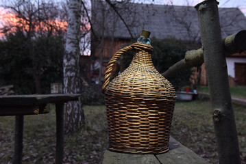 Wicker covered glass demijohn