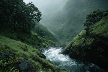 Vibrant green hills and misty mountains frame a powerful rushing river. Great for themes of wilderness, natural power, and environmental serenity.