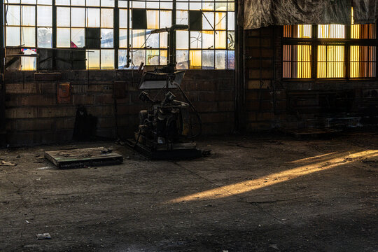 Abandoned industrial shop floor in dramatic sunlight