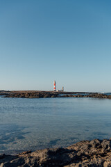 Vertical view of El Tost&oacute;n lighthouse with volcanic coastline