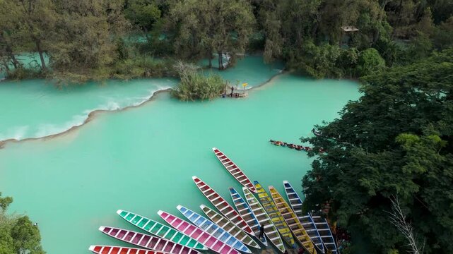 Barques in bright colors at a river in a tropical area on a sunny day