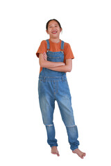 Cheerful Asian girl standing confidently with her arms crossed, wearing stylish denim overalls and an orange t-shirt, laughing happily against white background.