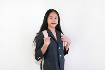 Asian girl carrying a backpack with looking you while standing against white background. Schoolgirl ready to take a class. Confident and ready.