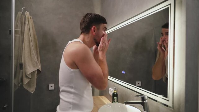 Man Applying Moisturizer to Face After Washing
