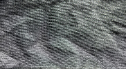 Texture of crumpled gray fabric as background, close up.
