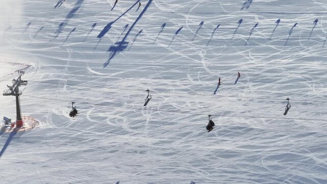 Winter ski resort with chairlifts and gondolas among snow-covered mountains