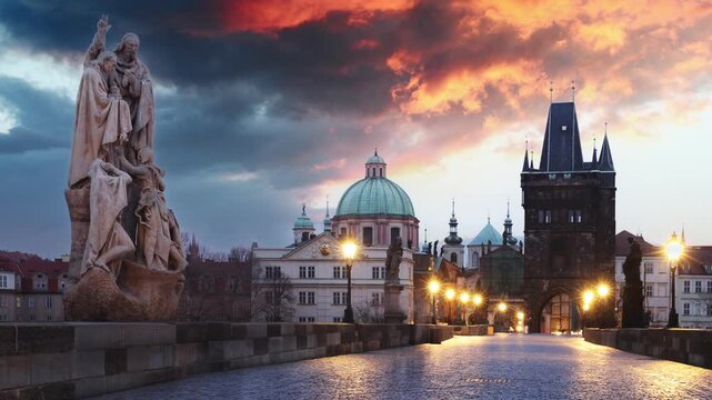Time lapse of Charles Bridge over River Vltava at dramatic sunrise in Prague, Czech Republic, Europe