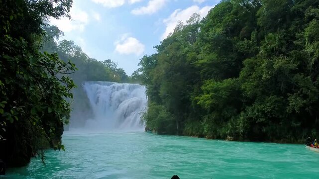 Explore El Meco Waterfall in El Naranjo, San Luis Potosi, Mexico on a sunny day with clear water and lush trees