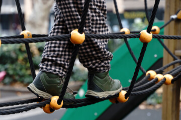 Playground Rope Climbing Structure with Toddler Legs in Focus