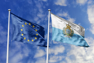 Waving flags of the European Union and San Marino together on blue sky background. Official diplomatic relations, partnership and business concept.