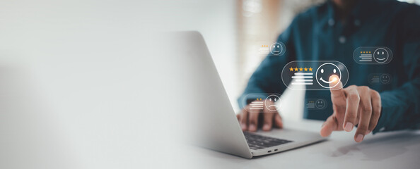 Business Evaluation and Positive Review , Man is using a laptop, pointing at a virtual happy face and five-star rating icon on a customer satisfaction survey interface.