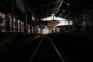 Obraz premium Dark or silhouette station with straight train rails into the light at Tugu Station Yogyakarta.