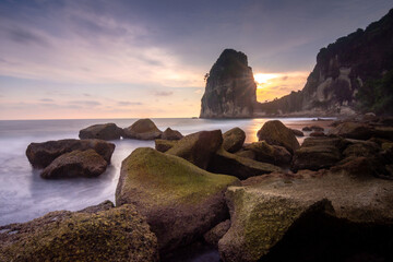 Scenic Sunset at Pangasan Beach Pacitan East Java With Mossy Rocks and Rock Formations