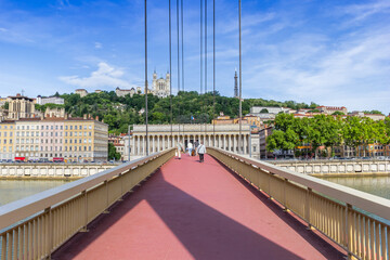 People walking the Pierre-Truche bridge over the Saone river in Lyon, France