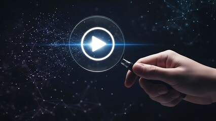 Magnifying glass reveals glowing play button icon with digital network hand holding