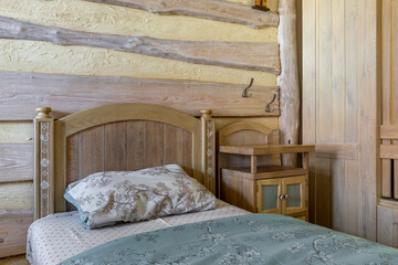 Traditional rustic bedroom with folk art bed and log wall decor