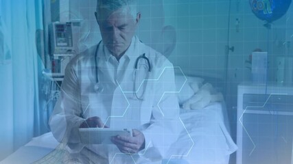 Animation of hexagons over senior caucasian male doctor with tablet