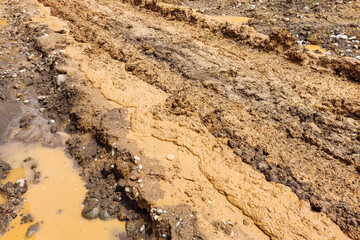 The texture of the road is muddy and mixed with old dirt.