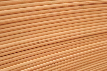 Fototapeta premium Diagonal pattern of cylindrical wooden rods or bed frame slats close-up.