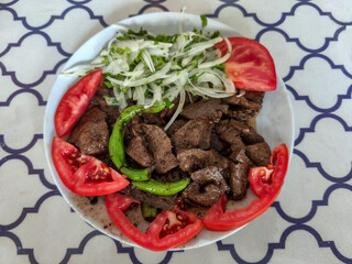 Liver stir-fry in a white plate