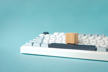 One square wood block on top of keyboard.