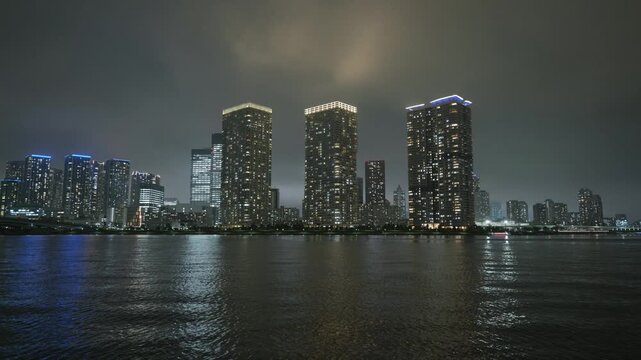 Night view of skyscrapers and sea in Koto City, Tokyo, Japan.