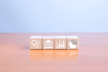 Business strategy and financial analysis using wooden blocks to represent processes, institutions, and growth charts is suitable for organizational planning and data analysis.