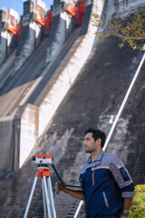 Blue collar worker is working at the dam.