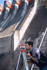 Blue collar worker is working at the dam.