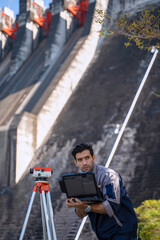 Blue collar worker is working at the dam.