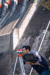 Blue collar worker is working at the dam.