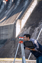 Blue collar worker is working at the dam.