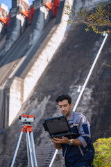 Blue collar worker is working at the dam.