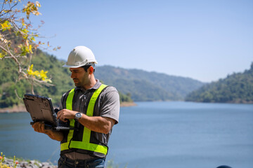 Blue collar worker is working at the dam.