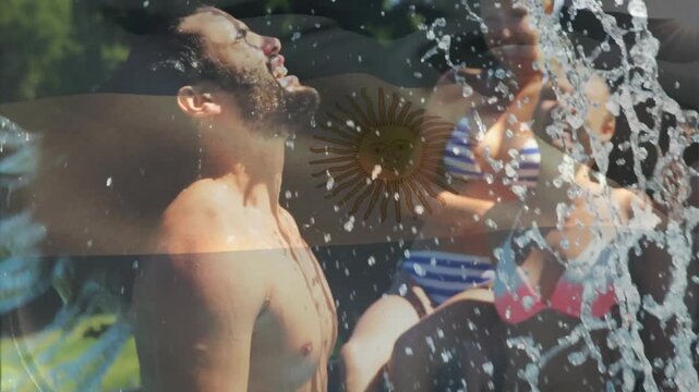 Water splashing with Argentina flag and sun emblem, people celebrating outdoors