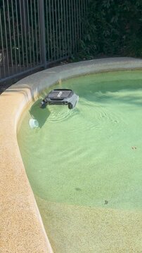 Automatic Robotic Pool Cleaner Moving Along the Edge of a Swimming Pool