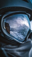 close up of snow goggles reflecting winter landscape