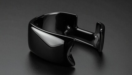   
Black ring with smooth polished surface and rounded exterior, displayed upright on plain white background.