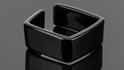   
Black ring with smooth polished surface and rounded exterior, displayed upright on plain white background.