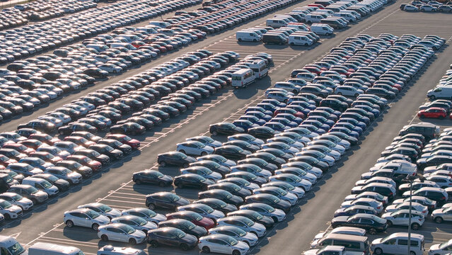 AERIAL: Massive parking lot is full of vehicles ready for global distribution.