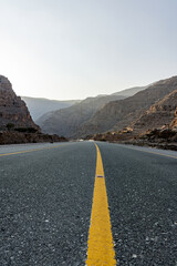 Mountain road background with a stunning view of Jebel Jais under a cloudy sky, a beautiful travel destination in Ras Al Khaimah.