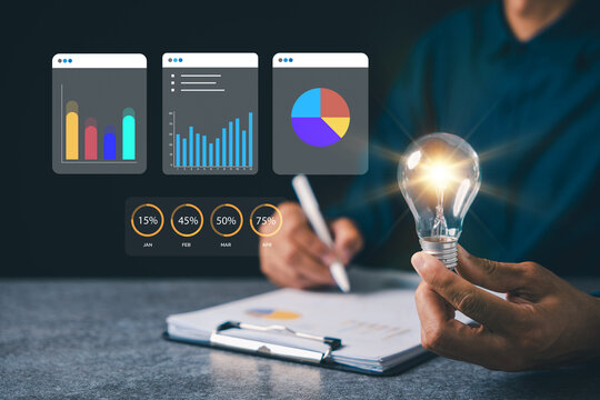 Light bulb business manager career project concept innovation strategy creative energy vision glows while professional performs document management using digital analytics charts - Powered by Adobe