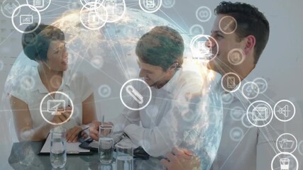 Collaborating at table, business team in office with animation of digital icons - Powered by Adobe