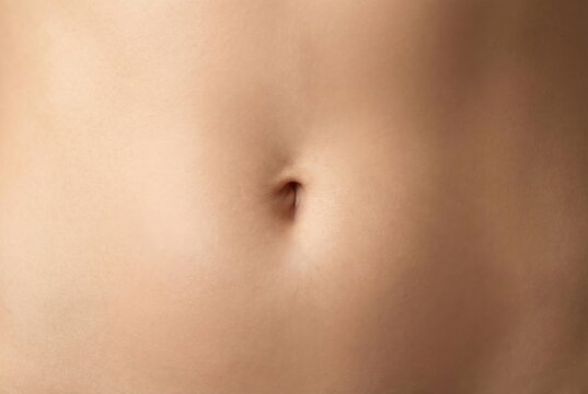 Close-up macro shot of a human navel, showing skin texture and detail