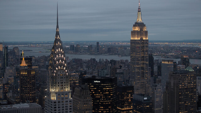 CLOSE UP: Lit up Empire State Building and Chrysler Building after the sunset