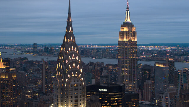 CLOSE UP, AERIAL: Detailed Chrysler Building terraced crown glowing in the dark