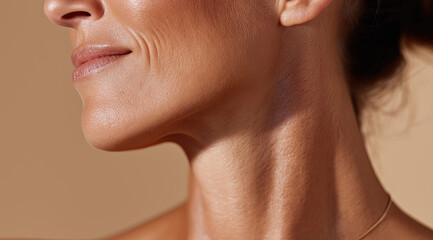 Closeup neck and jawline show mature skin texture under warm light.
