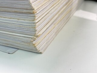 Piles of old papers were stacked on top of each other.