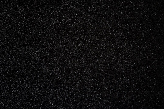 Texture of black foam plastic.